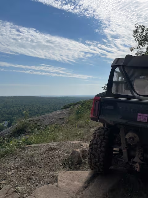 ORV parked near a high scenic overlook with broad Upper Peninsula views